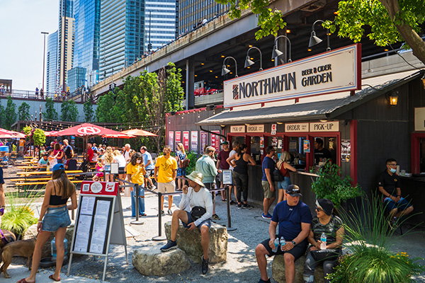 Patrons gathering at The Northman Beer & Cider Garden on the Chicago Riverwalk.
